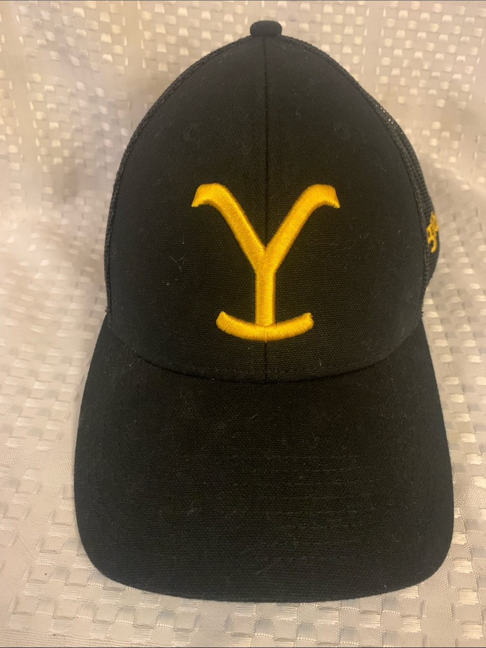 Yellowstone Wrangler black hat with yellow logo, adjustable.